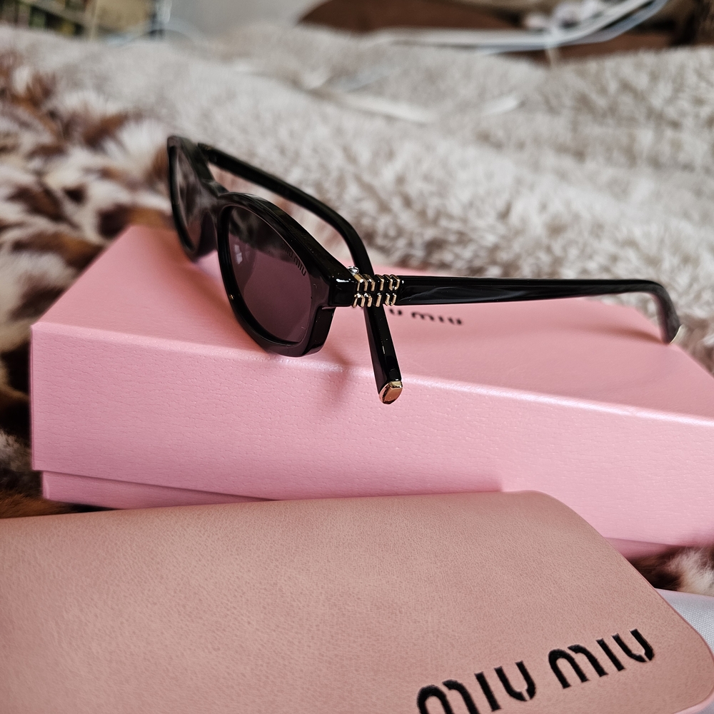 Miu Miu Black Cat-Eye Sunglasses with Gold Accents 😎